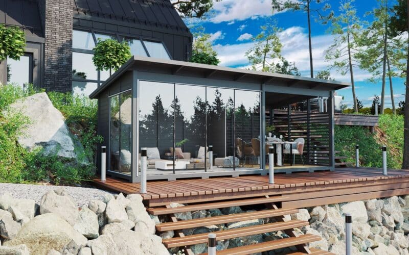 Modern grey garden room with glass wall and veranda